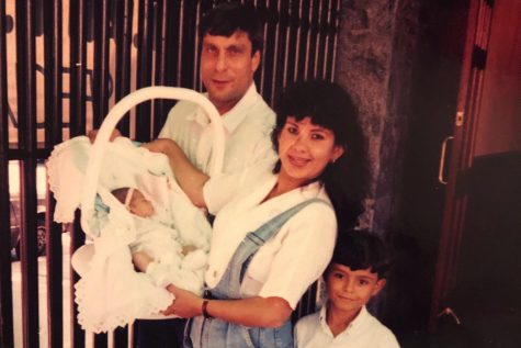 Stephanie Ulan, as an infant in a carrier, poses with her father, mother and brother.