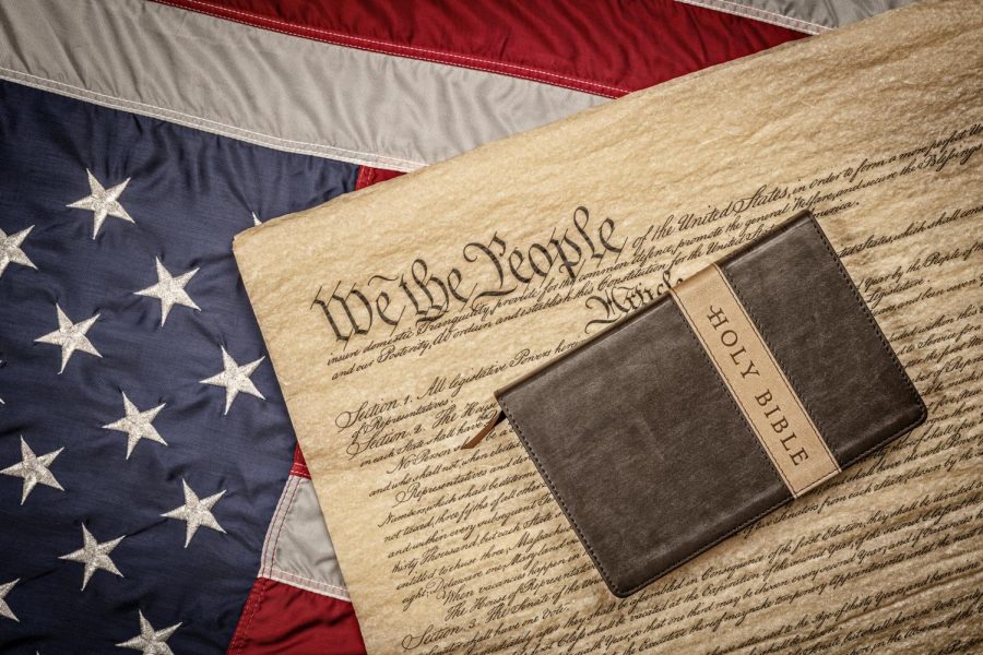American flag with the U.S. Constitution and the Holy Bible.