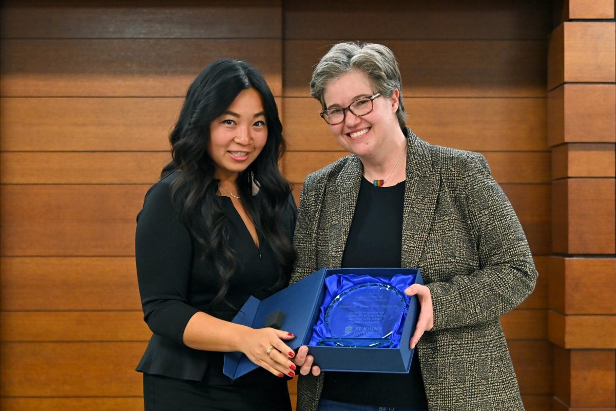 Genie Cesar-Fabian (right) accepts the Erica B. Fine '82 Public Interest Champion Award presented by last year's recipient, Olivia Cheung '17 